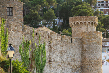 Fragment of the fortress wall with watchtowers in the town of Tossa de Mar (Spain)