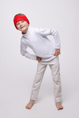 young boy in a headband in the studio on a white background