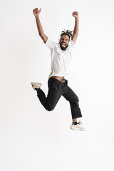 Fototapeta na wymiar Photo of jumping while dancing african american guy in headphones jumping while dancing