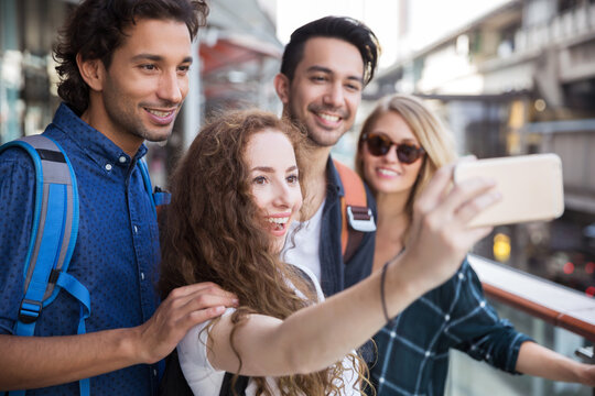 Group of friends talking a selfie together
