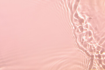 de-focused. Closeup of pink transparent clear calm water surface texture with splashes and bubbles....