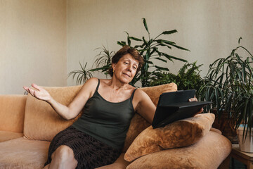 Happy senior elderly woman using tablet video call and talking with family. Video chat social distancing. Stay home save lives from coronavirus covid-19. Self isolation.