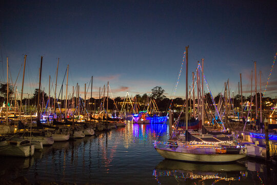 Boats in a harbor decorated with lights for Christmas