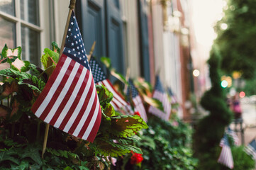 American flags outside homes on a street