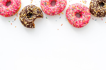 Donuts flat lay pattern on white background, top view