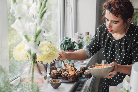 Woman Decorating Muffins
