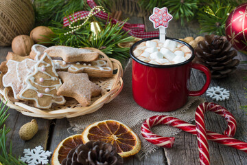 Red metal cocoa mug with marshmallows and glazed cookies. Christmas and New year.