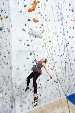 Pregnant woman rock climbing indoor