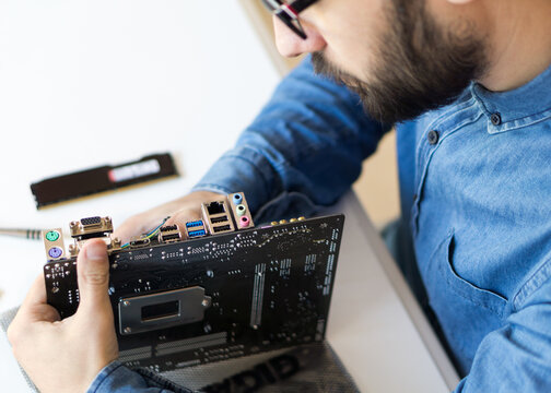 Man repairing motherboard computer
