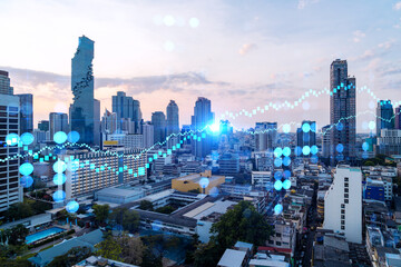 Obraz premium Glowing FOREX graph hologram, aerial panoramic cityscape of Bangkok at sunset. Stock and bond trading in Asia. The concept of fund management. Double exposure.