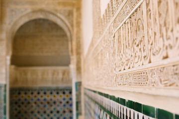 Detail of a wall with Arabic symbols and colorful moscaics in the alhambra, granada, spain
