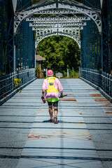 Woman walking alone over bridge in Windsor in Upstate NY