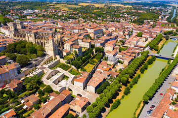 Fototapeta na wymiar Aerial view of colorful Auch cityscape on Gers river with Sainte-Marie Cathedral and Tour d Armagnac on sunny summer day, France..