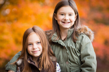 Happy Sisters Together During Autumn Outside