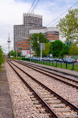 Fototapeta na wymiar Mannheim, Germany. April 30th, 2010. View on the tracks of the city tram, in the background the Collini Center building in the Neckar area.