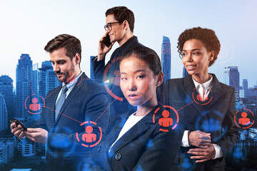 Group of SMM specialists working on social media marketing strategy to achieve business goals. Hologram icons over Bangkok background.