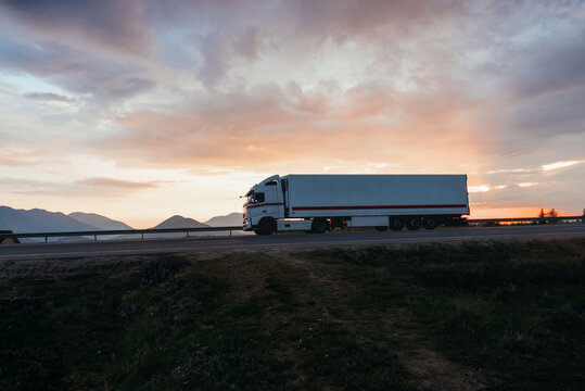 White semi truck in motion on the road