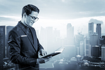 Young handsome businessman in suit and glasses thinking how to tackle the problem, new career opportunities, MBA assignment. Singapore on background. Double exposure.