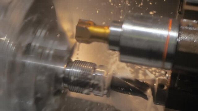 Slow motion: turning milling machine with cooling system cutting metal workpiece at factory, plant, exhibition. Metalworking, engraving, industrial, equipment, technology, manufacturing concept