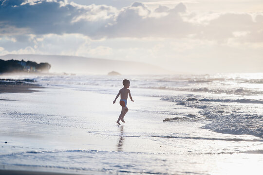 Boy running to water