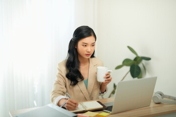 Head shot pleasant happy young woman freelancer working on computer at home.