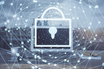 Double exposure of desktop with computer and lock icon hologram. Concept of data safety.