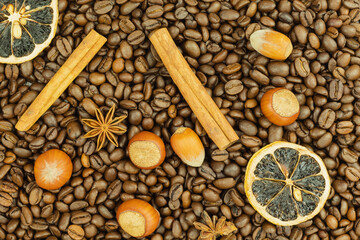 Coffee beans and nuts with cinnamon as a background