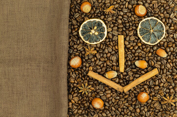 Obraz na płótnie Canvas Coffee beans and nuts with cinnamon as a background