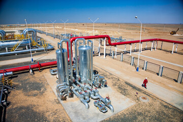 Aktobe region/Kazakhstan - May 04 2012: Oil refinery plant in a desert. Panorama. Red pipes, metal...