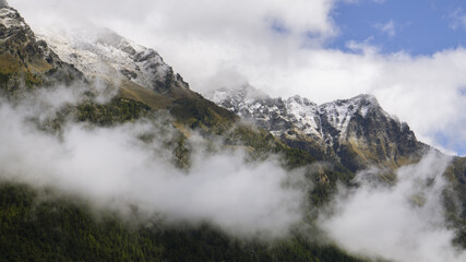 View of Corno Bussola (Valle d'Ayas, AO) surrounded by clouds and covered by snow after a storm in august