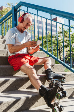 Healthy Senior on Using Cell Phone LIstening to Music in the City