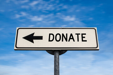 Donate sign. White street signs with arrow on metal pole with word. Directional road. Crossroads Road Sign, Arrow. Blue sky background. Charity.