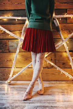 Crop woman in skirt on tiptoes