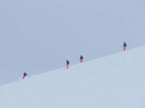 Skiers descending a ski slope on a cold winter day