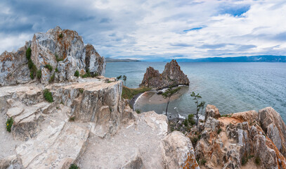 A panoramic view of the sacred Shamanka rock against the backdrop of a dramatic sky and stormy...