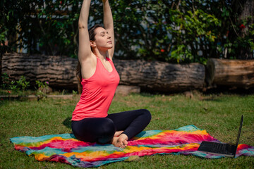 Woman practicing pilates lesson online