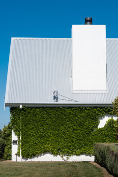 Detail of pitched roof and chimney of modern farmhouse design
