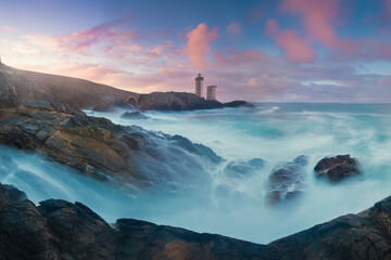 Petit Minou Lighthouse at sunset with red light , Brest , France View of Lighthouse of Petit Minou in Brittany. Summer season in France coastline. Most popular lighthouse in Europe.