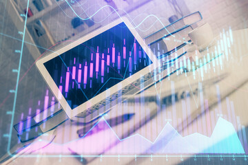 Forex market chart hologram and personal computer background. Multi exposure. Concept of investment.