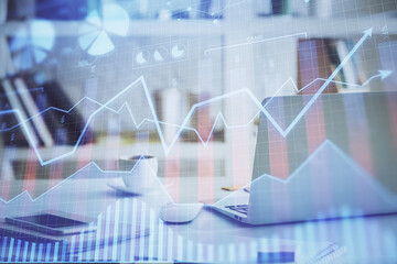 Forex market graph hologram and personal computer on background. Double exposure. Concept of investment.