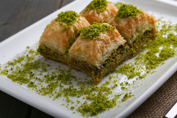 Baklava with pistachio on a white plate close up