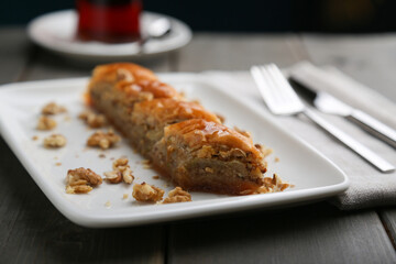 Baklava with walnut on a white plate with tea