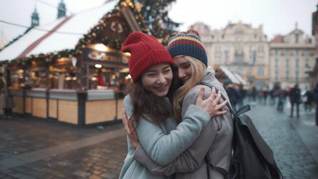 Lesbian couple in love at xmas time. Prague old town square. Pride, lgbt, love, friendship, christmas, holiday, vacation concept.