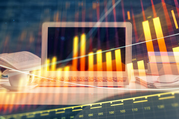 Forex market chart hologram and personal computer background. Double exposure. Concept of...