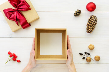 Empty box for a gift on a wooden table. Gift for Christmas and New Year.