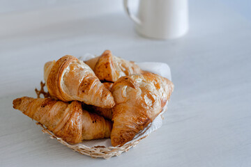 Homemade freshly baked croissants on a grey rustic table. Croissant bread on wooden, top view. France food and breakfast.