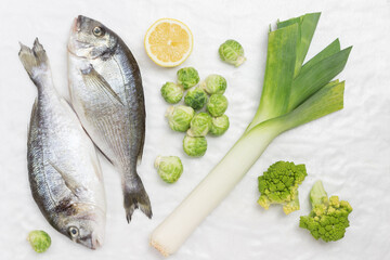 Raw fish with green vegetables.