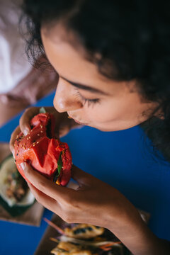 Cropped Female Enjoying Cheat Meal Day For Eating Delicious Street Food - Burger With Mixed Ingredients, Woman Taste Tomato Cheeseburger With Apetito During American Caloric Dinner In Bistro