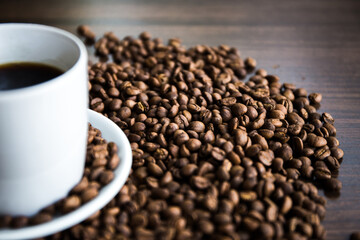 Coffee cup with coffee bag on wooden table. View from top,Roasted coffee beans
