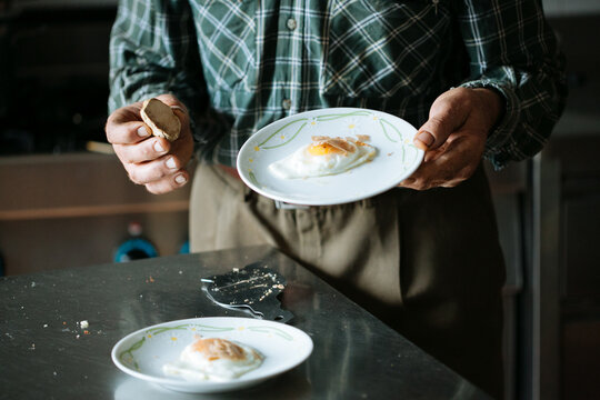 A person putting truffle on eggs